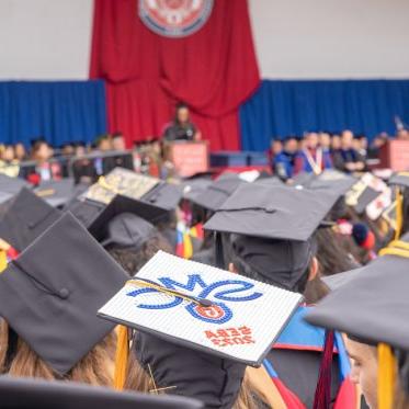 Graduation caps of students graduating. One that has the SMC logo and says SEBA 2023