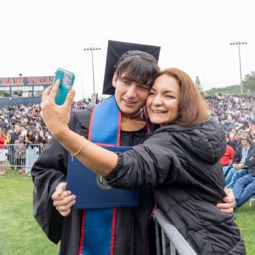 A graduating student and parent taking a selfie